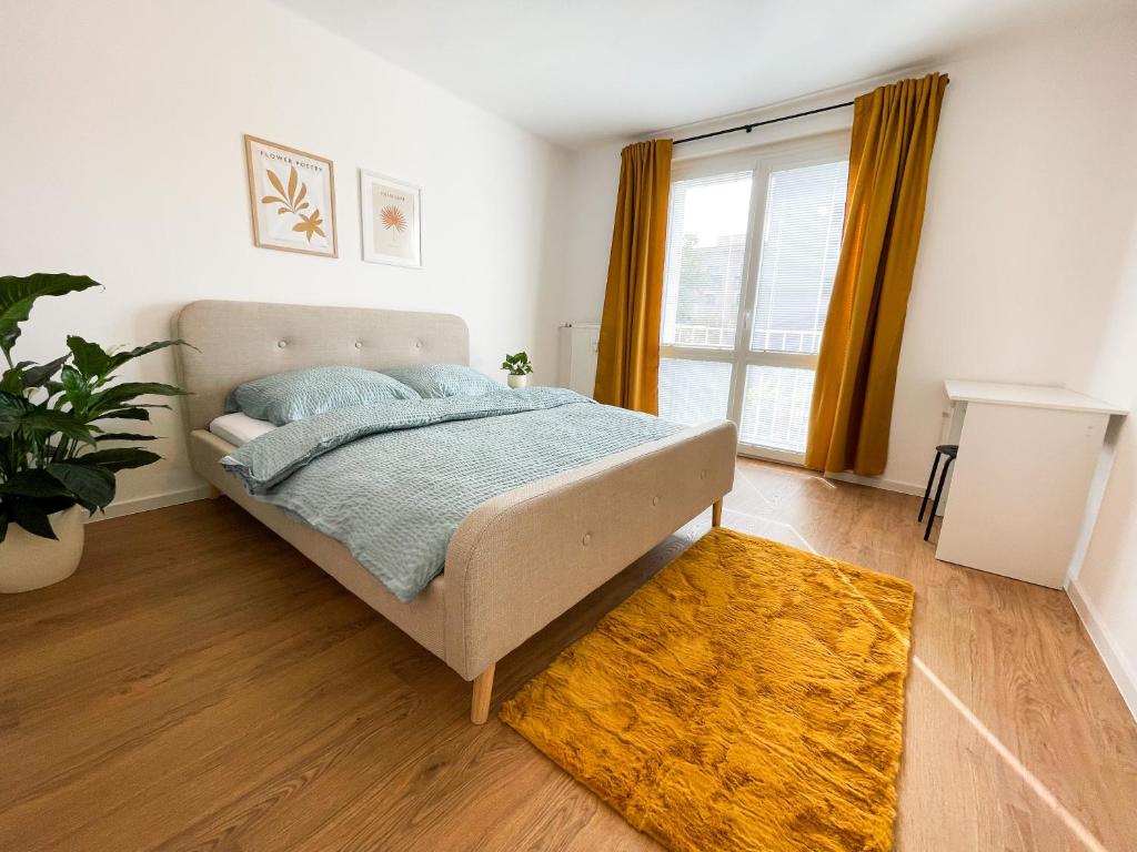 a bedroom with a bed and a large window at Modern Oasis in the Heart of the City in Košice