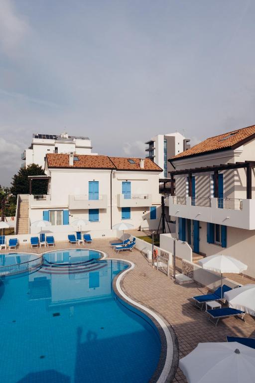 a view of a swimming pool next to a building at ANIMA JESOLO - DRAGO VILLAGE, Beach & Pool, 2 Parkings in Lido di Jesolo