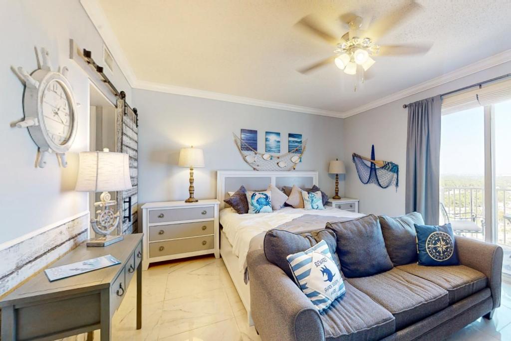 a bedroom with a bed and a couch at Boardwalk Beach Resort 1900 in Panama City Beach