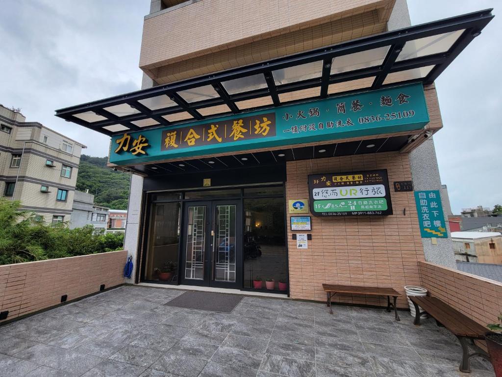 um edifício com uma placa na frente dele em 悠而行旅 em Nangan