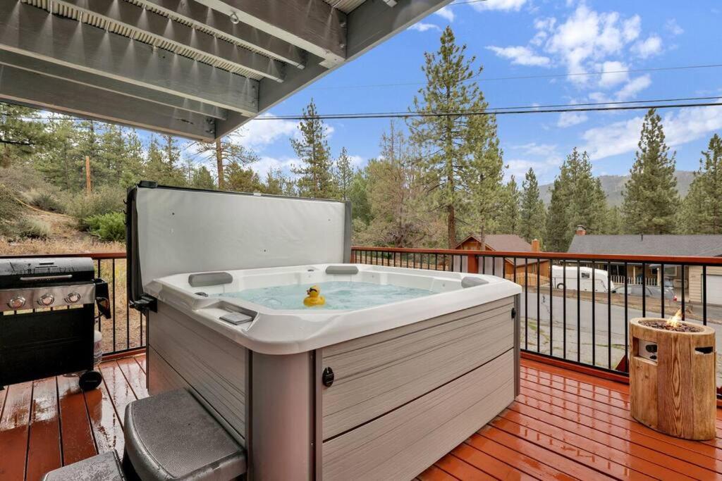 a jacuzzi tub on the deck of a house at Ursa Minor- Modern Resort Chalet- Hot Tub in Big Bear Lake