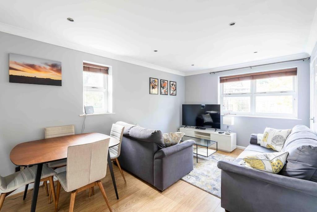 a living room with a couch and a table at Quiet 2 bed flat in SW London Parking Inc in Teddington