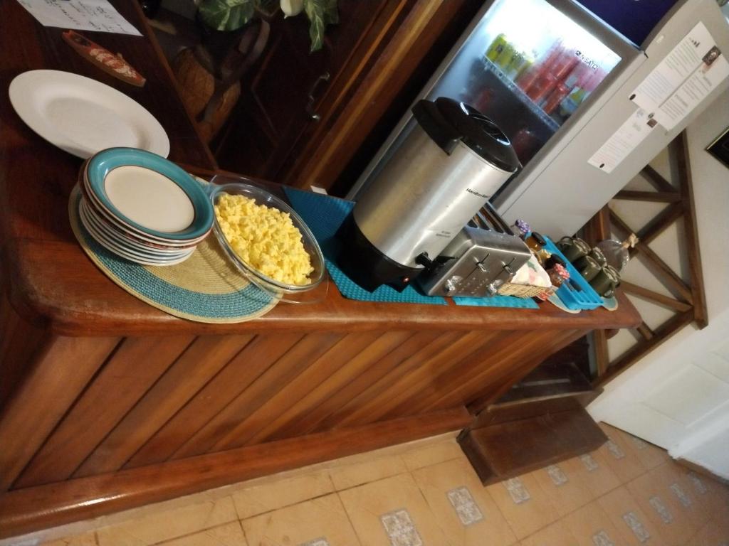 a counter with plates and bowls of food on it at Hotel Tierra Verde Bed and Breakfast in Bocas del Toro