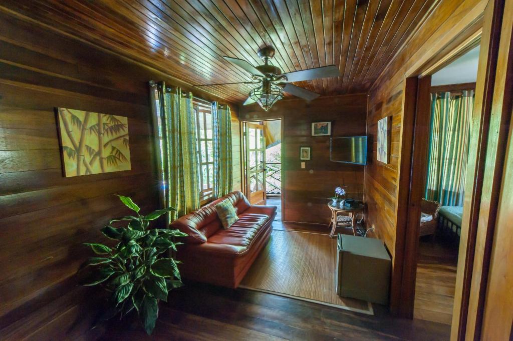 a living room with a couch and a ceiling fan at Tierra Verde Bed & Breakfast in Bocas del Toro