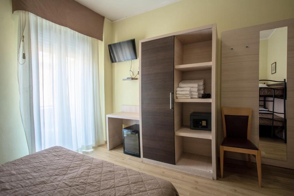 A bed or beds in a room at Hotel Bamby
