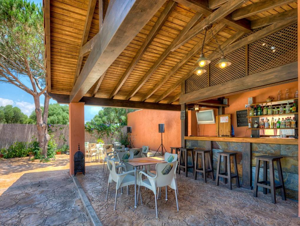 an outdoor bar with chairs and a table at Hostal Alhambra in Zahora