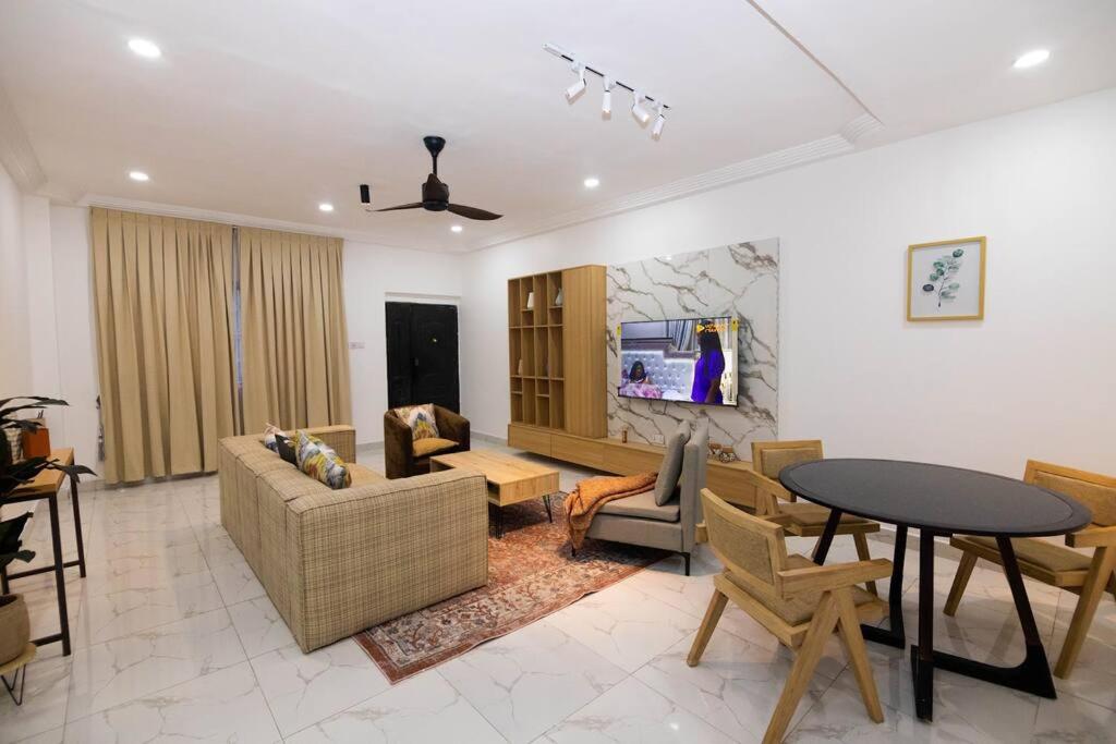 a living room with a couch and a table at Big chill stays East Legon in Accra