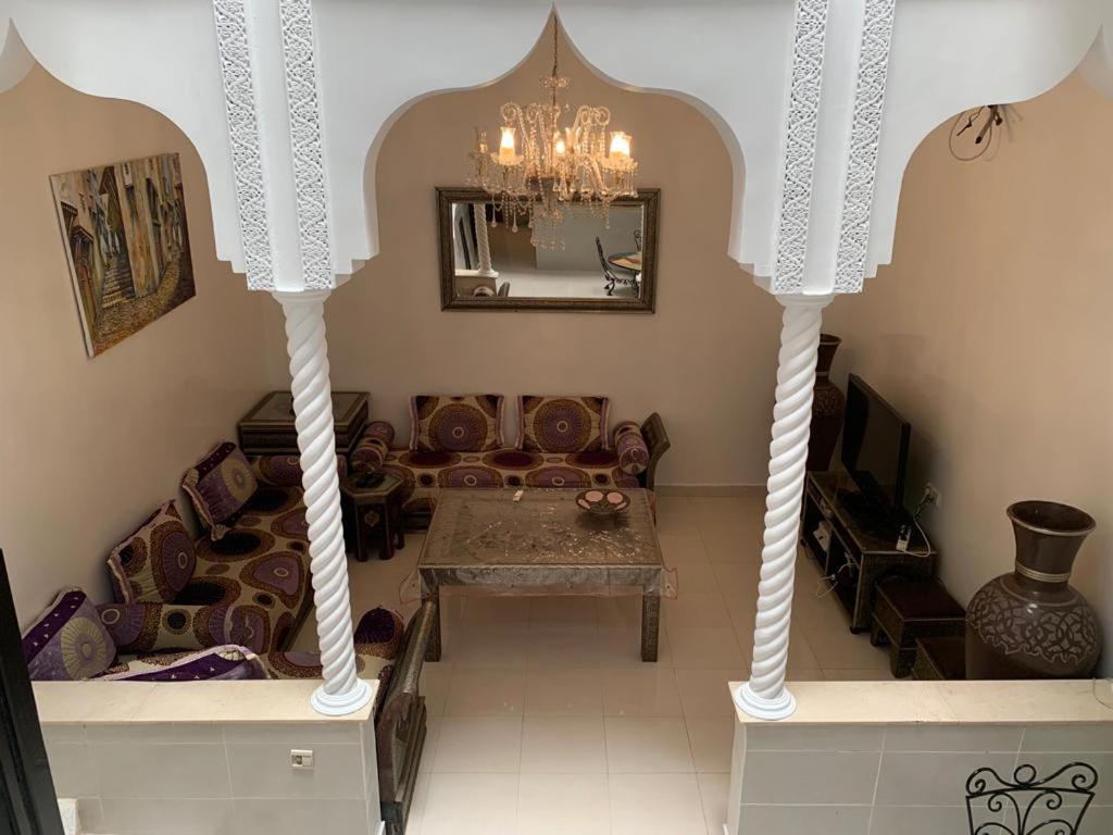 a living room with a couch and a table at Riad lalla aicha in Marrakech