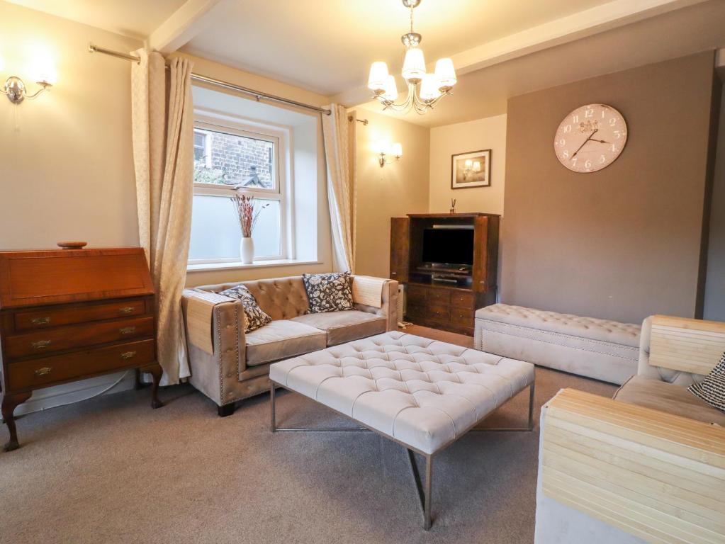 a living room with a couch and a table at 20 Wool Road in Oldham