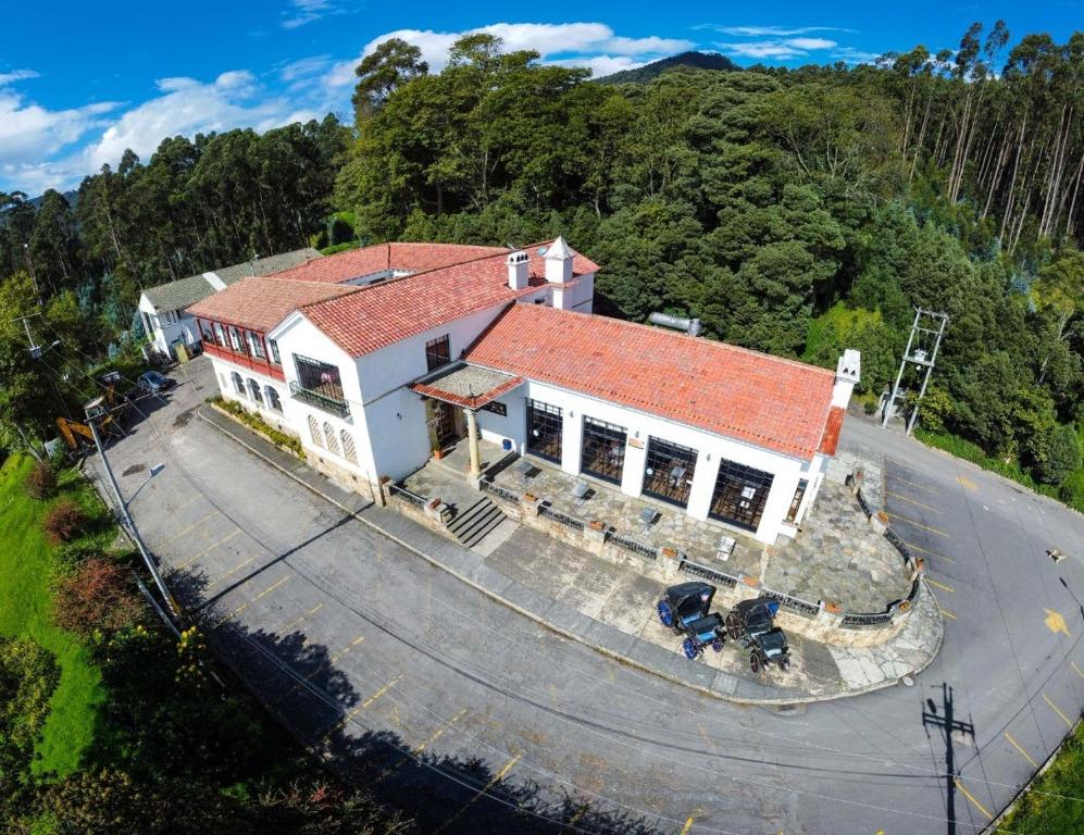 an overhead view of a house with a red roof at Hotel Boutique El Libertador in Zipaquirá