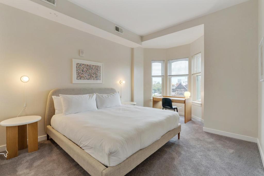 a bedroom with a large white bed and windows at Mint House at The Divine Lorraine Hotel - Philadelphia in Philadelphia