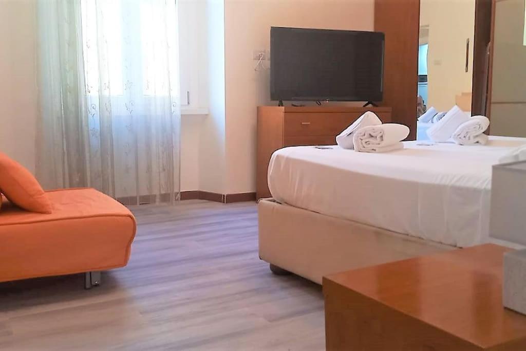 a hotel room with two beds and a television at Cozy flat in Testaccio in Rome