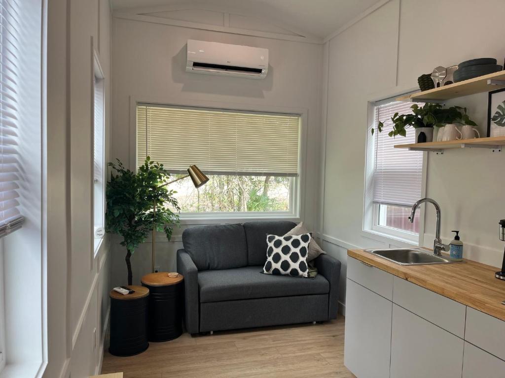 a living room with a chair and a window at The Sam Tiny Home in Perry