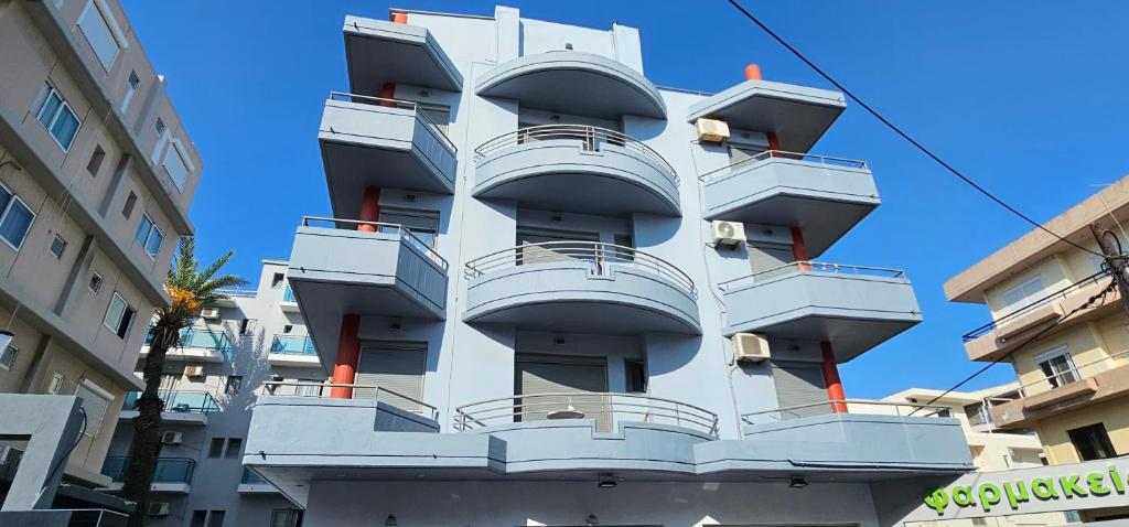 a white building with balconies on the side of it at North Bay Apartments in Rhodes Town