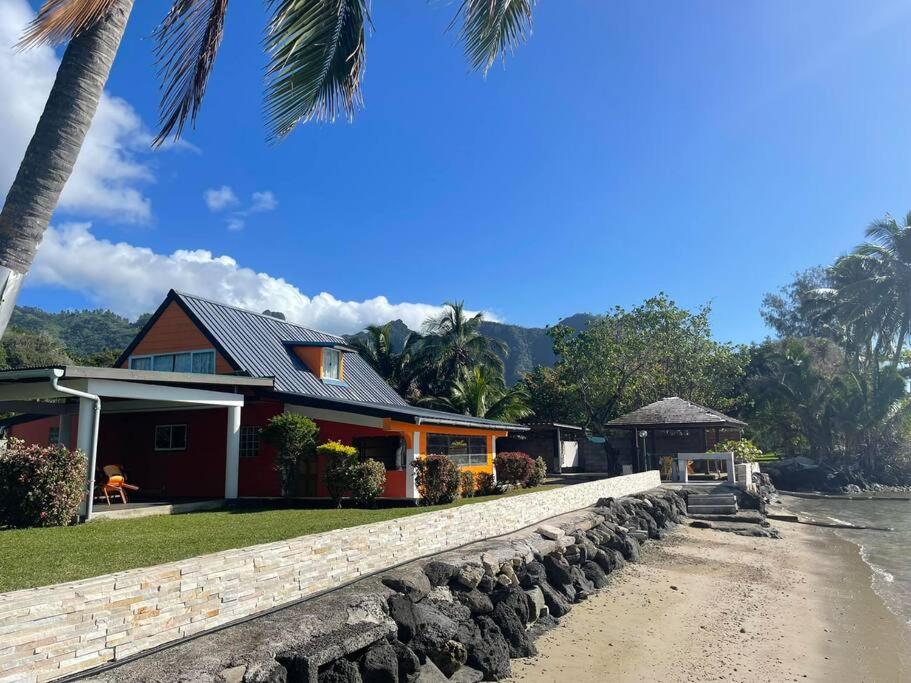a house on the beach next to the water at FARE AHIATA MOOREA in Moorea