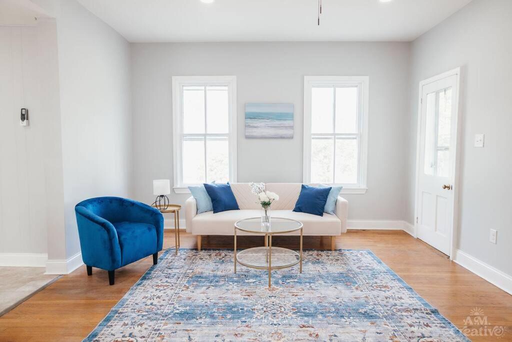 a living room with a couch and a blue chair at Near Waterfront, Maryland Renovated Home - Walk to Historic Downtown! in Cambridge