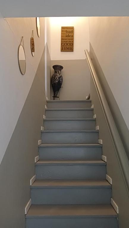 a stairway with a vase sitting on top of it at Cassiopée avec jardin in Fleury-les-Aubrais