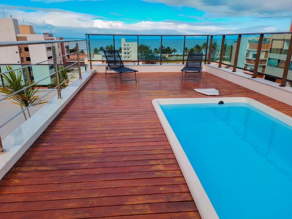 a balcony with a swimming pool on top of a building at Flat Comfort Vista Mare Studios - Intermares in Cabedelo