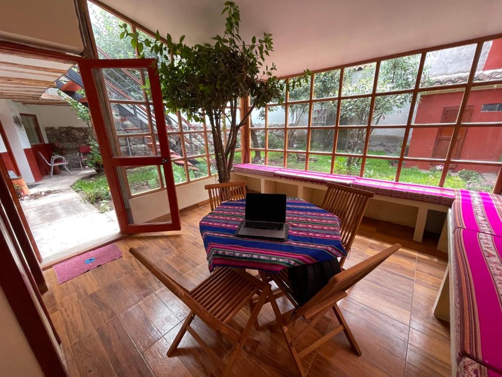 a balcony with a table with a laptop on it at Anka Wasi Lodging in Cusco