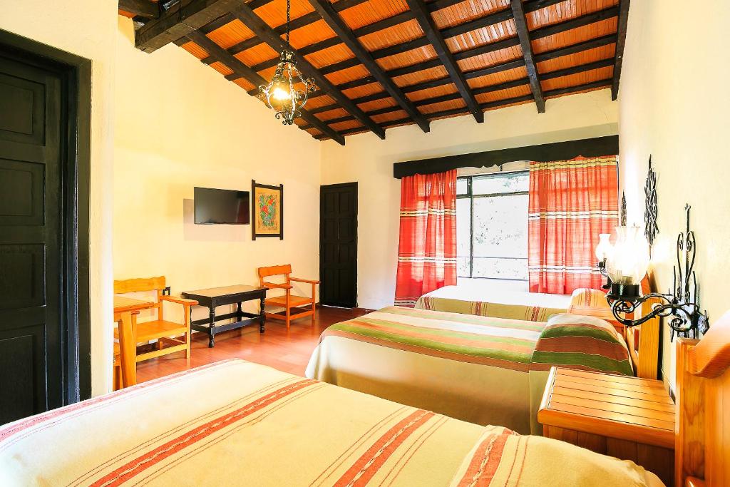 Postel nebo postele na pokoji v ubytování Hotel Pie de la Sierra