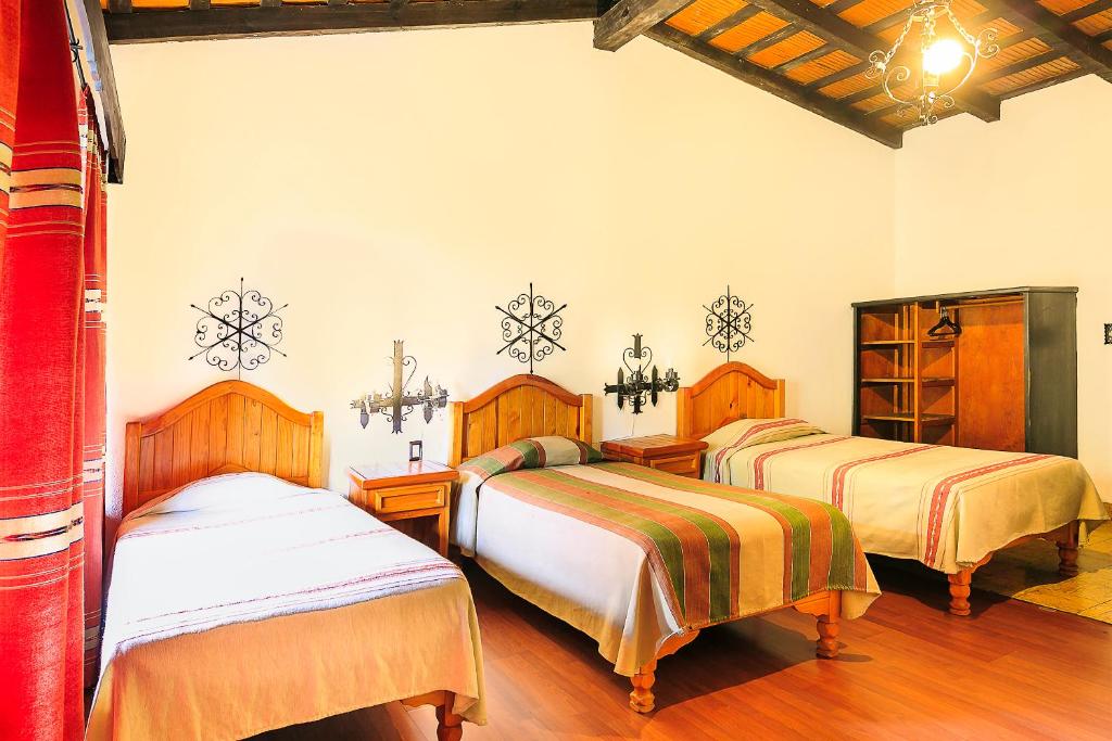 Postel nebo postele na pokoji v ubytování Hotel Pie de la Sierra