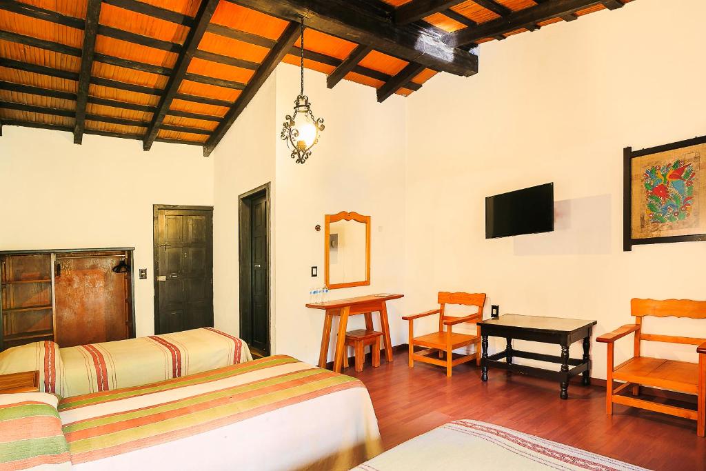 Postel nebo postele na pokoji v ubytování Hotel Pie de la Sierra