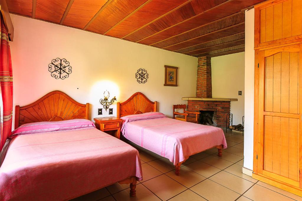 Postel nebo postele na pokoji v ubytování Hotel Pie de la Sierra