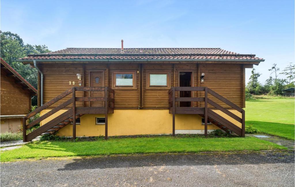 a house with a large deck on the side of it at Cozy Home In Oberharz With Kitchen in Waldschlösschen