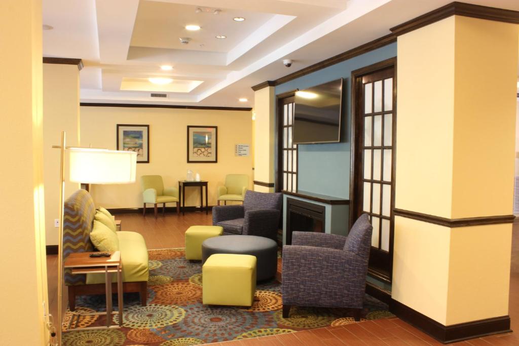 a waiting room with chairs and a fireplace at Holiday Inn Express & Suites Lebanon, an IHG Hotel in Lebanon