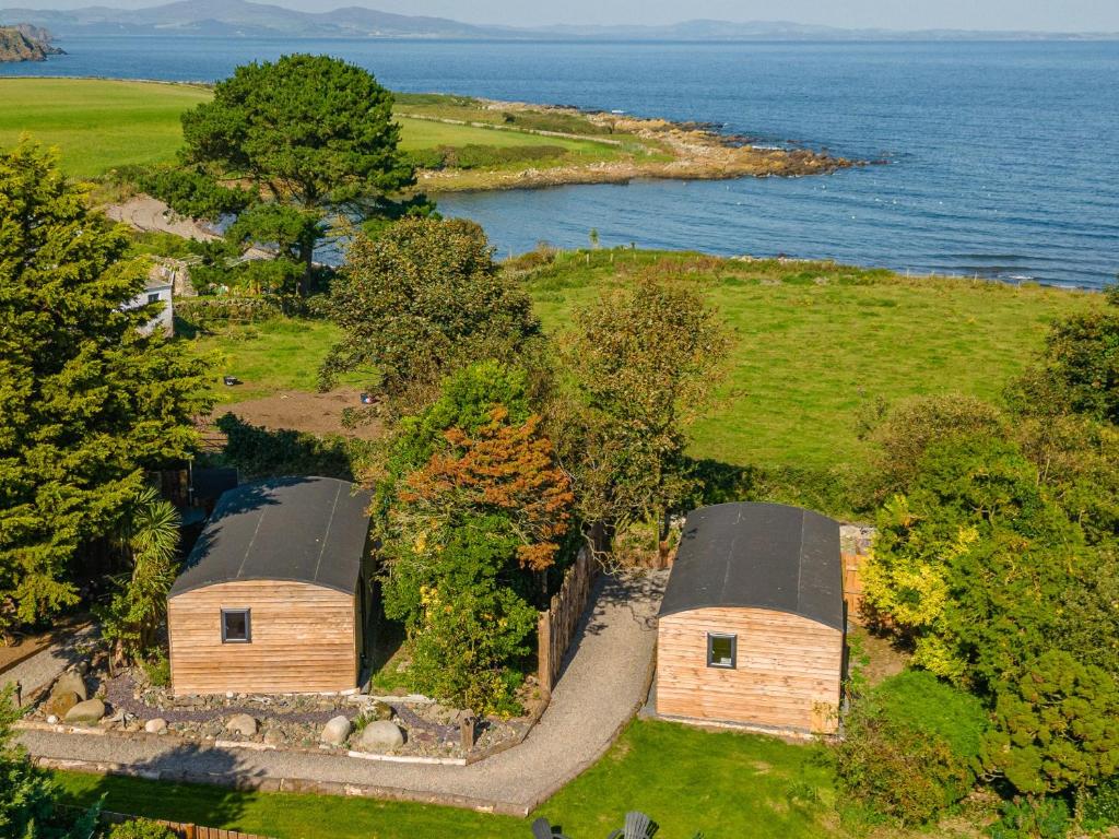 an aerial view of a house on an island in the water at Orchard Cabin-rowan - Uk45435 in Isle of Whithorn