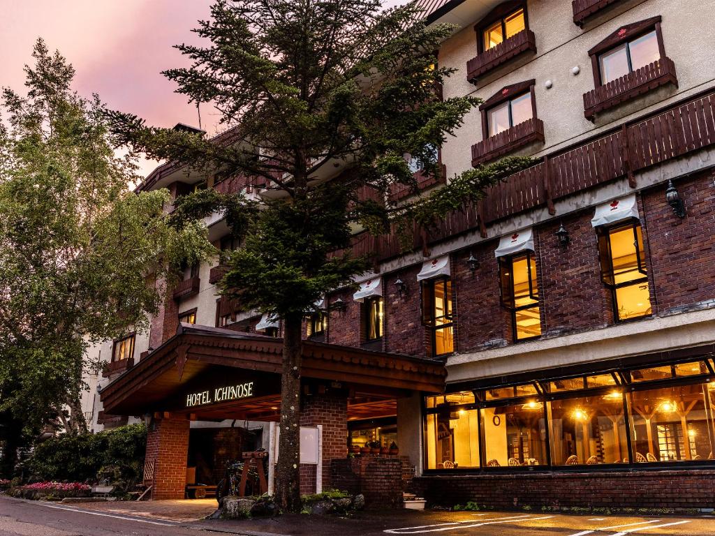 a building with a tree in front of it at Hotel Ichinose in Yamanouchi