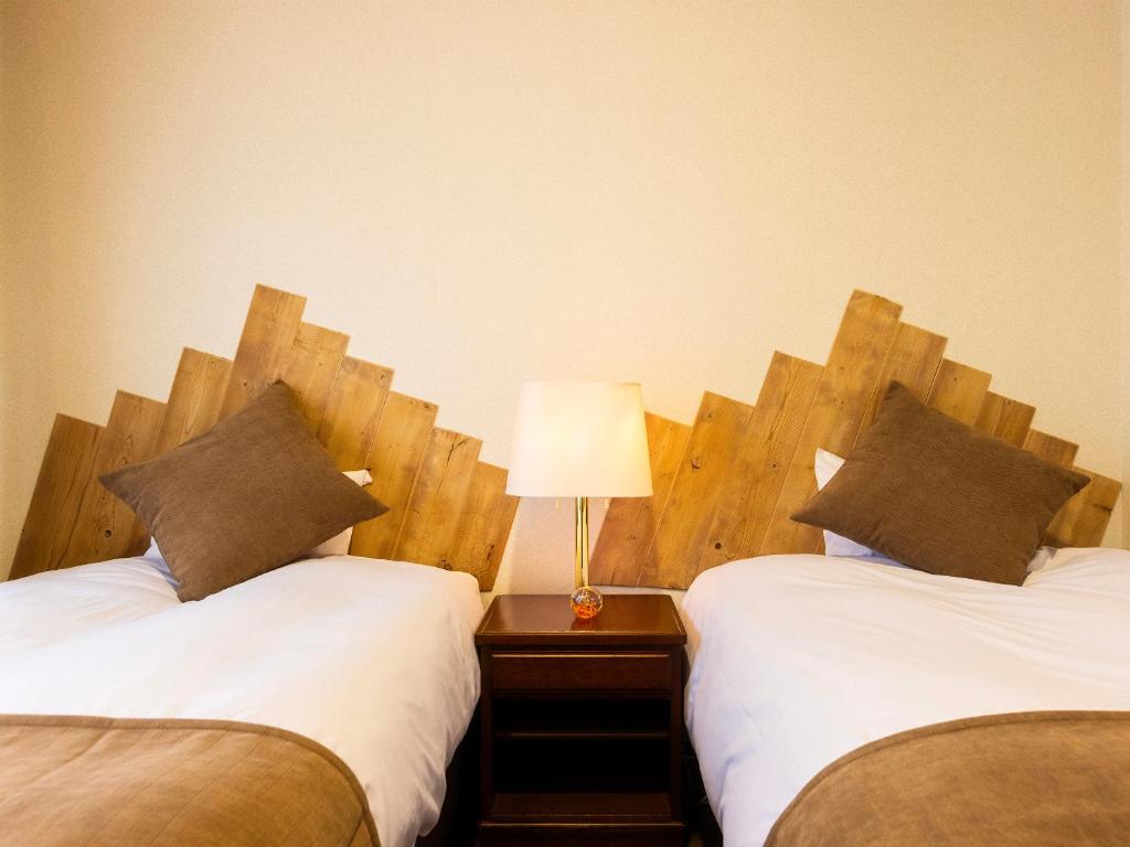 Postel nebo postele na pokoji v ubytování Hotel Ichinose
