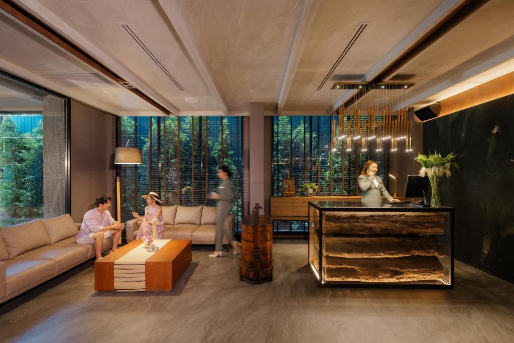 A warmly lit lobby lounge with sofas and a reception desk.