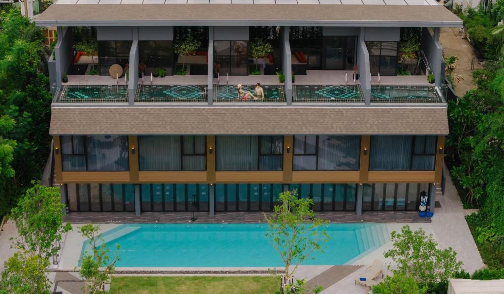 An aerial view shows the outdoor pool beside the hotel building.