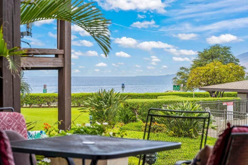 a patio with a table and a view of the ocean at Hale Kamaole 7-169- Ground floor, ocean view, updated Kihei gem in Wailea
