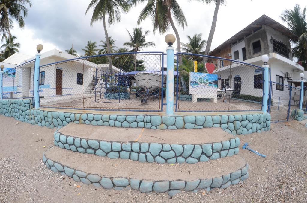 a basketball hoop with rocks around it in front of a house at Isla Water Sports and Resorts Inc in Batangas City