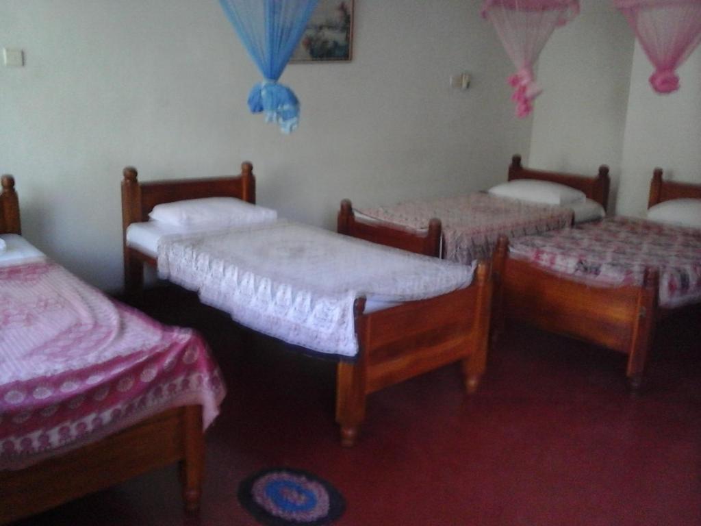 Postel nebo postele na pokoji v ubytování Majestic Tourist Hotel