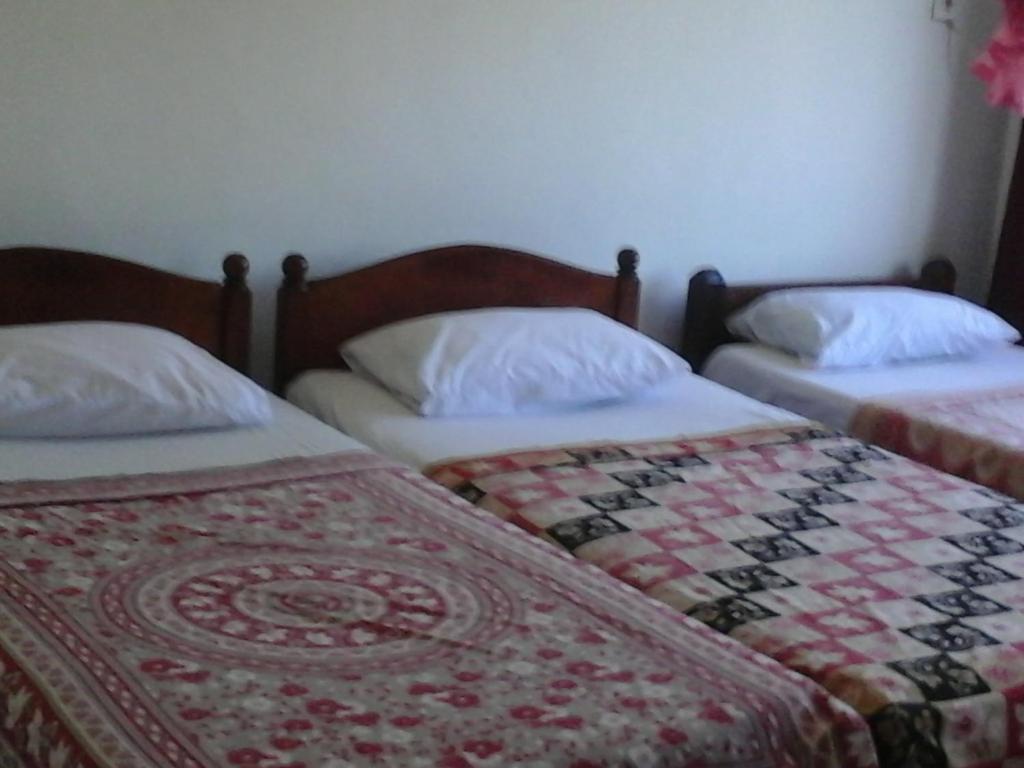 Postel nebo postele na pokoji v ubytování Majestic Tourist Hotel