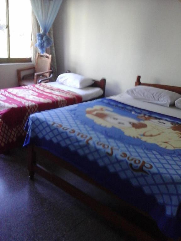 Postel nebo postele na pokoji v ubytování Majestic Tourist Hotel