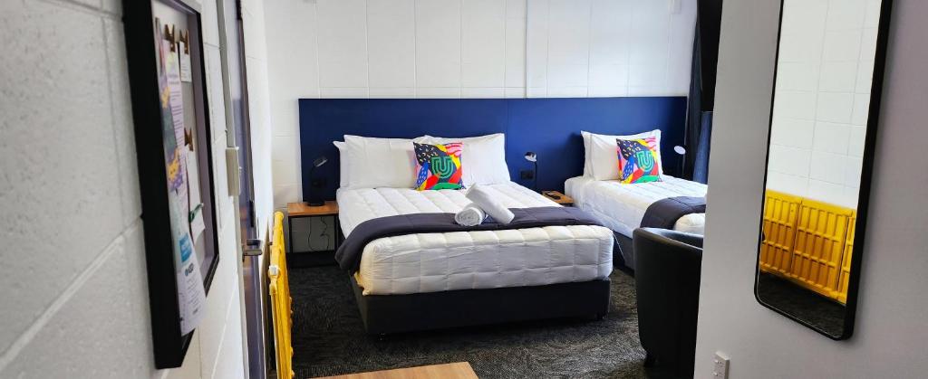 a bedroom with two beds and a mirror at Urban Lounge Sleepery, SureStay Collection by BW in Rotorua