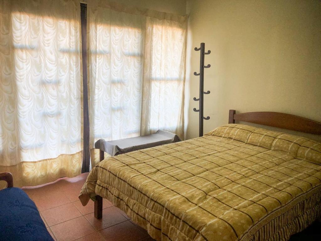 a bedroom with a bed and a window at Hostal Juanita in Vallegrande
