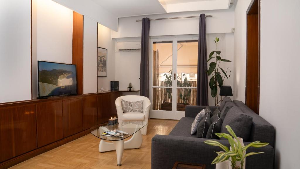 a living room with a couch and a chair at Quiet City Center Apt on a Pedestrian Street in Athens