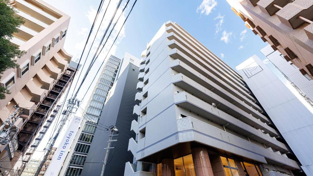 a tall building in the middle of a city at Toyoko Inn Sendai Higashi-guchi No.1 in Sendai