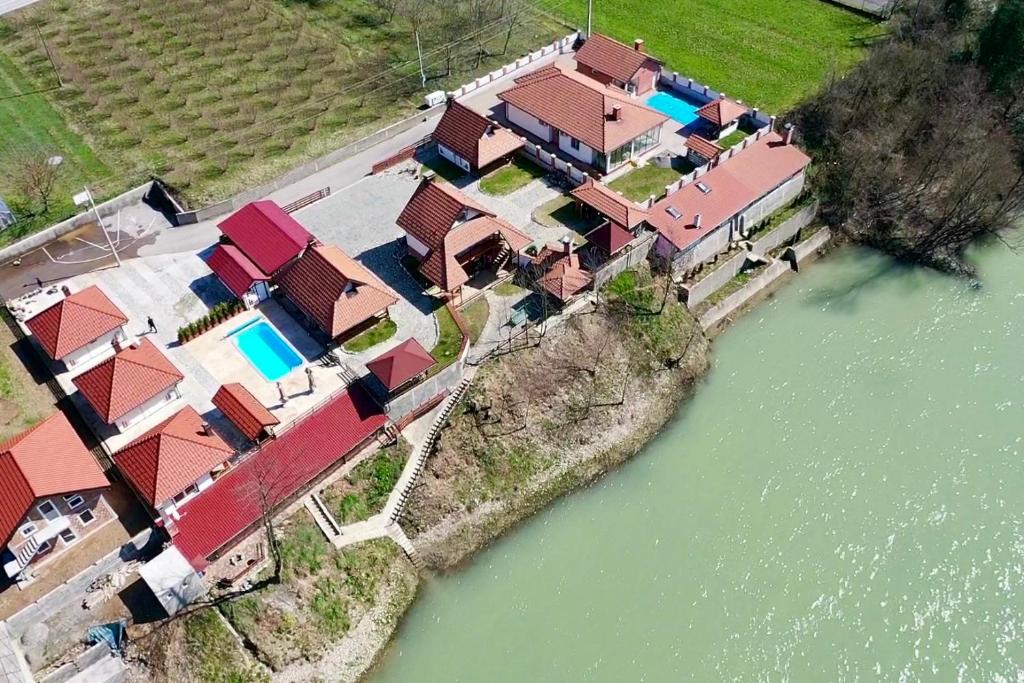 an aerial view of a group of houses next to a river at Grande Apartman Nature Connection Drina in Bajina Bašta