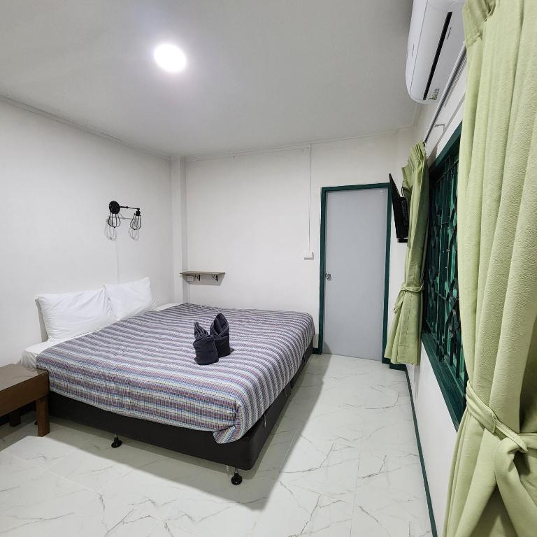 Postel nebo postele na pokoji v ubytování Chandra Home - จันทรา โฮม