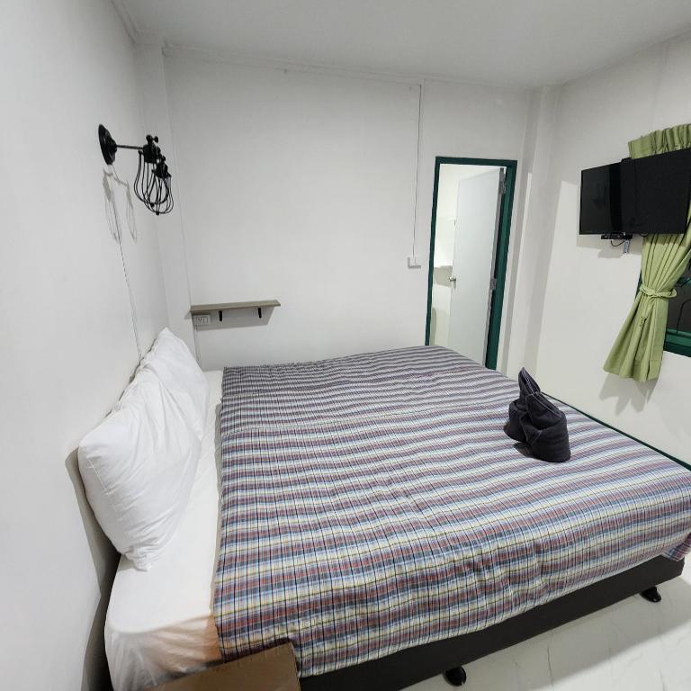 Postel nebo postele na pokoji v ubytování Chandra Home - จันทรา โฮม