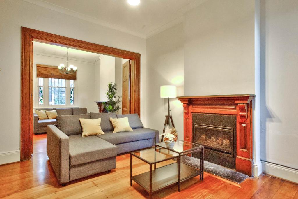 a living room with a couch and a fireplace at 3 Bedrooms - Darling Harbour - Darghan Street 2 E-Bikes Included in Sydney