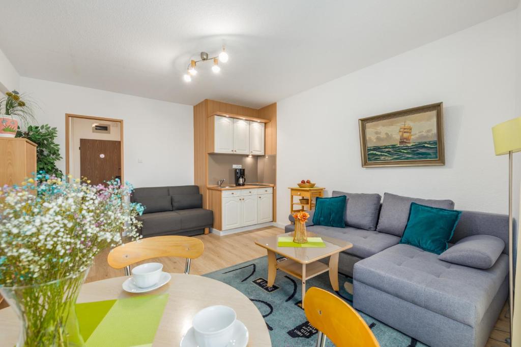a living room with a couch and a table at Comfy Studio Turystyczna 300 m to the beach by Renters in Międzyzdroje