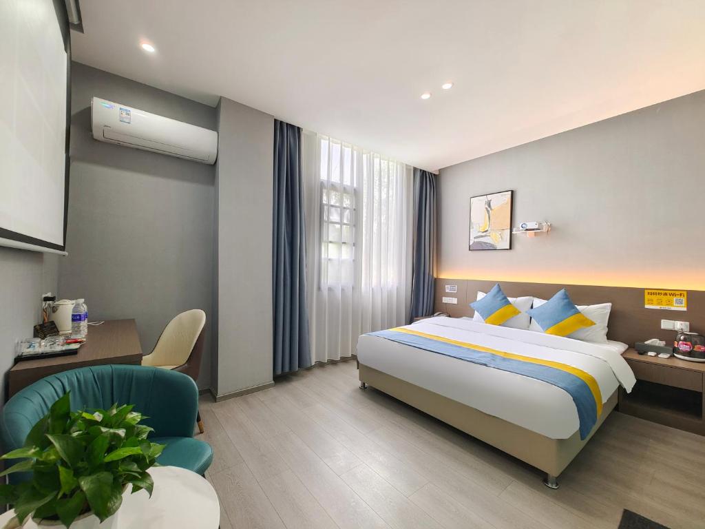 a hotel room with a bed and a chair at Xian Feng Hotel - Tianfu International Airport Branch in Jianyang