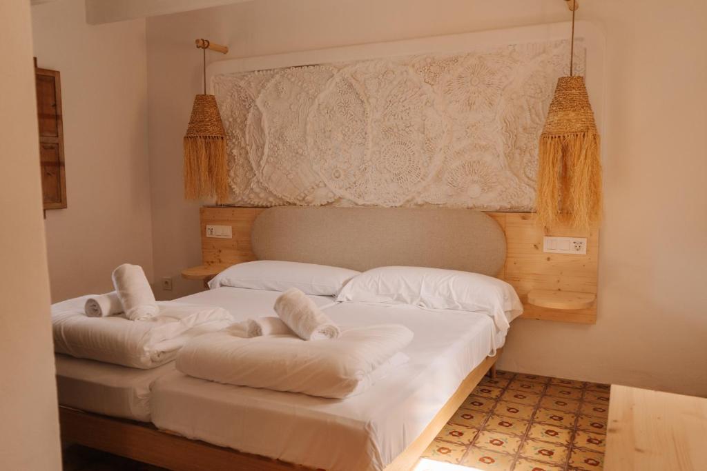 two beds in a room with white sheets at Claudia by Nura in Campos